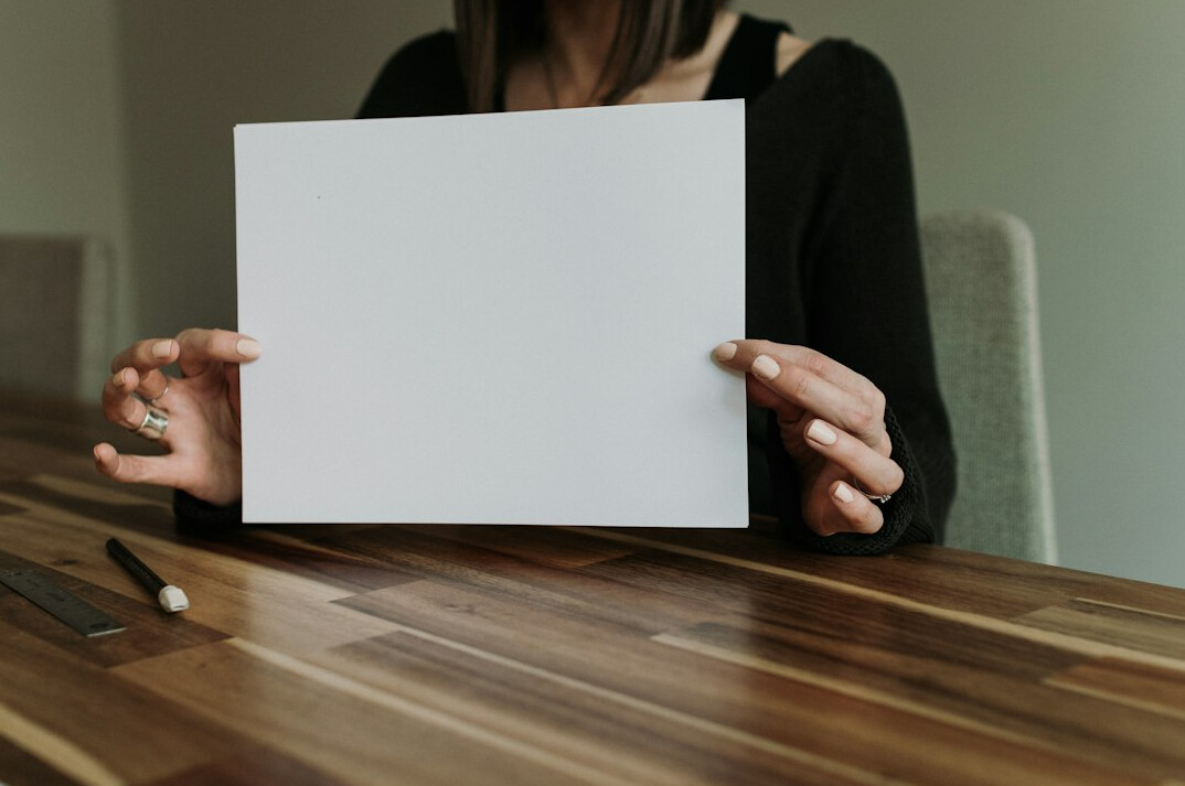 Person reading a printed investigative report at a desk