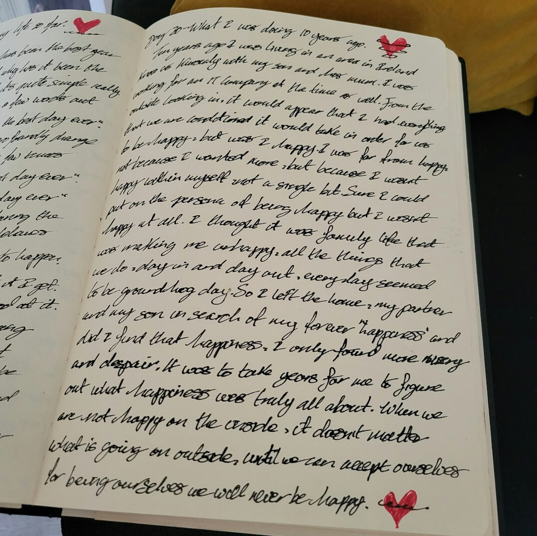 Open notebook with handwritten notes and a pen on a desk