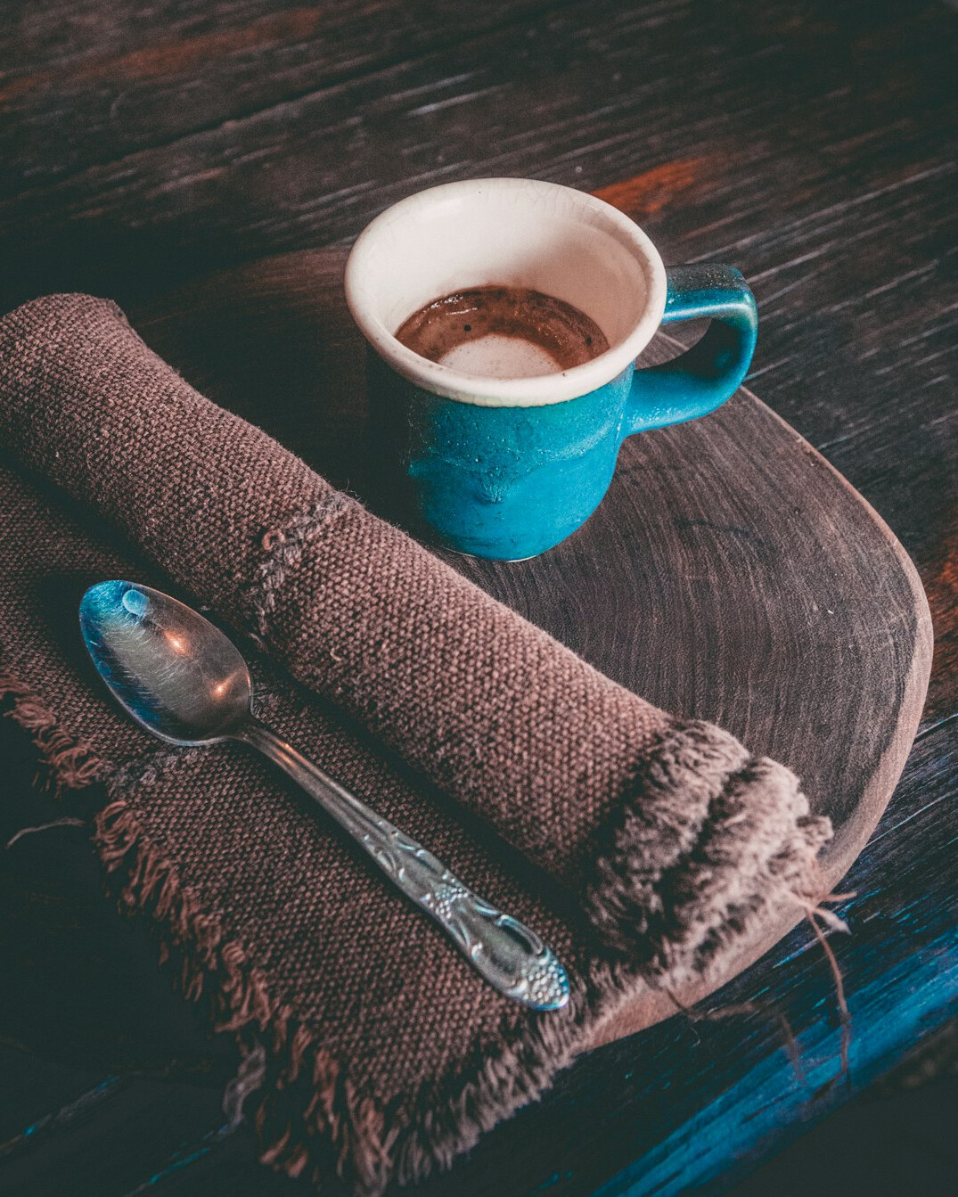 Rolled newspapers and a cup of coffee on a wooden table